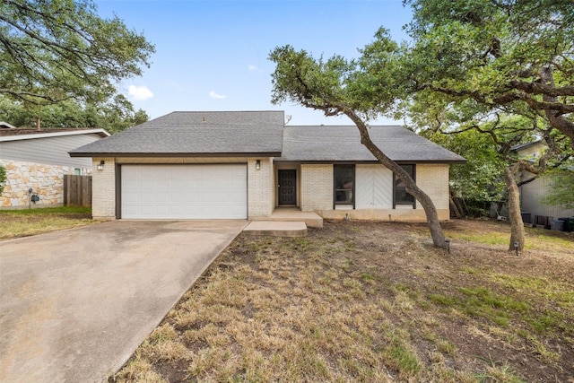 single story home with a garage and a front lawn