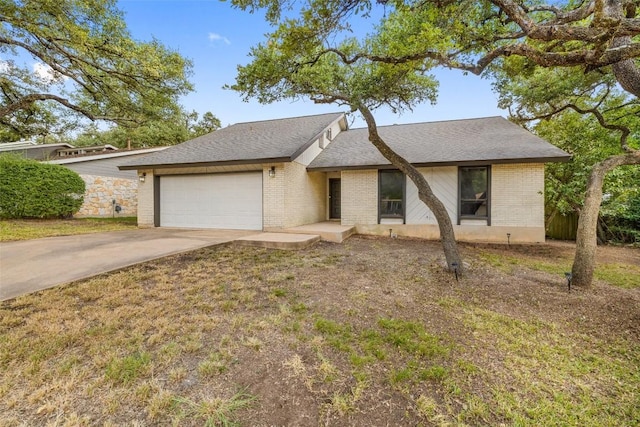 6700 Colina Ln, Austin, TX 78759 - view of front of property featuring a garage, concrete driveway, and brick siding