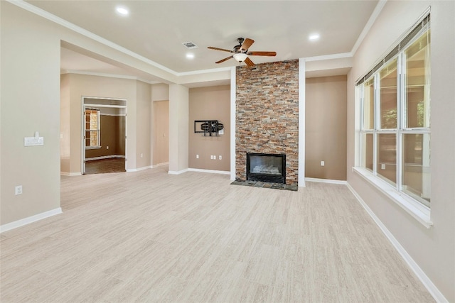 unfurnished living room featuring a stone fireplace, ceiling fan, crown molding, and light wood-type flooring