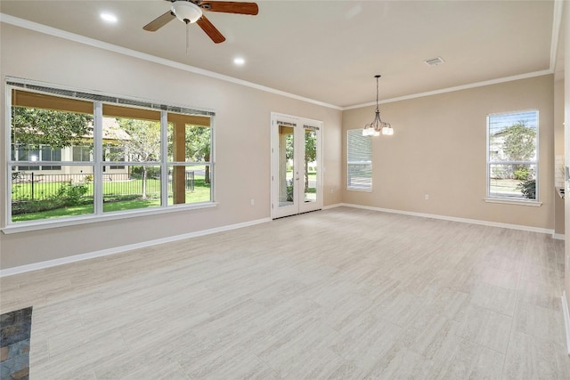 empty room with ceiling fan with notable chandelier and crown molding