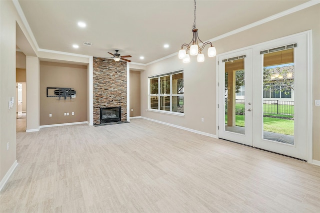 unfurnished living room with crown molding, a fireplace, light hardwood / wood-style floors, and ceiling fan with notable chandelier