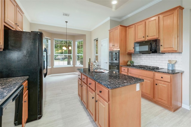 kitchen featuring dark stone counters, decorative light fixtures, decorative backsplash, a kitchen island, and black appliances