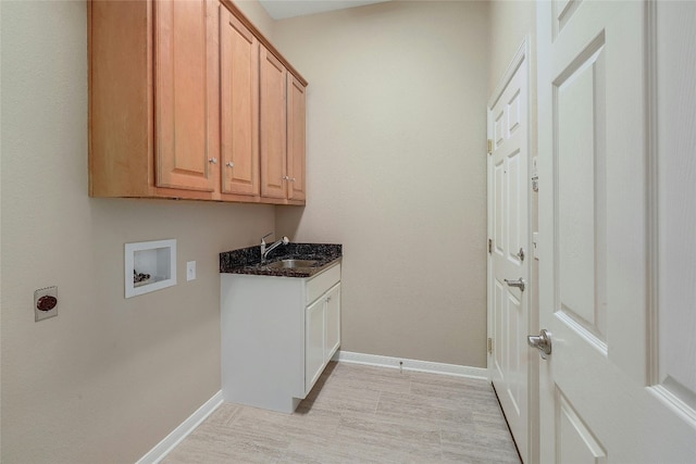 laundry area featuring electric dryer hookup, hookup for a washing machine, cabinets, and sink