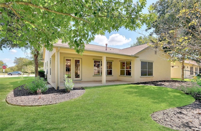 back of house featuring a patio area and a yard