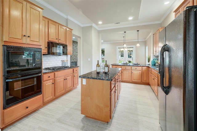 kitchen featuring black appliances, decorative backsplash, dark stone countertops, decorative light fixtures, and kitchen peninsula