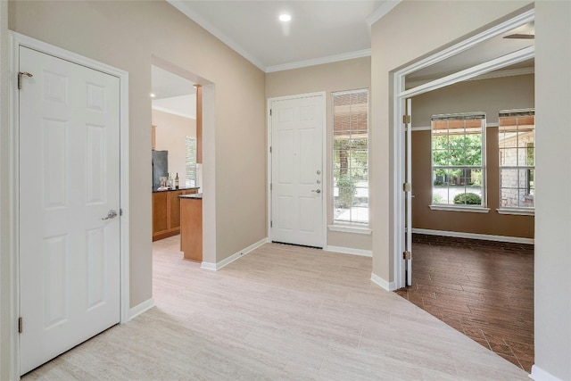 entrance foyer featuring light hardwood / wood-style floors and ornamental molding