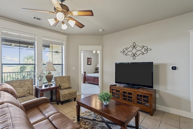 living room with ceiling fan and light tile patterned floors