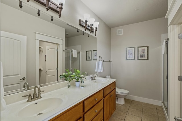 bathroom featuring walk in shower, vanity, tile patterned flooring, and toilet