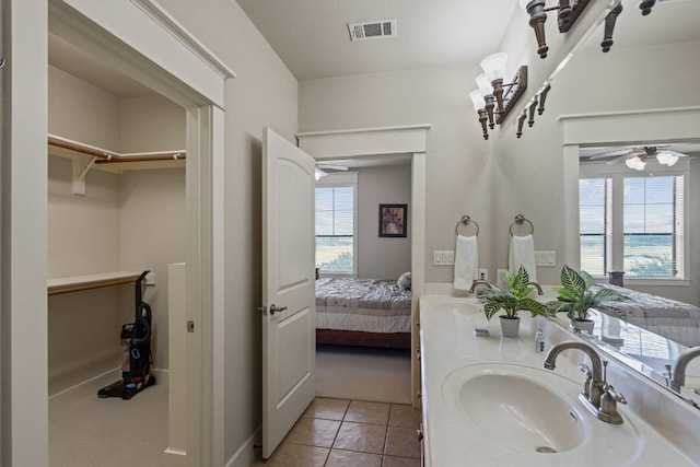 bathroom featuring vanity, ceiling fan, tile patterned floors, and a textured ceiling