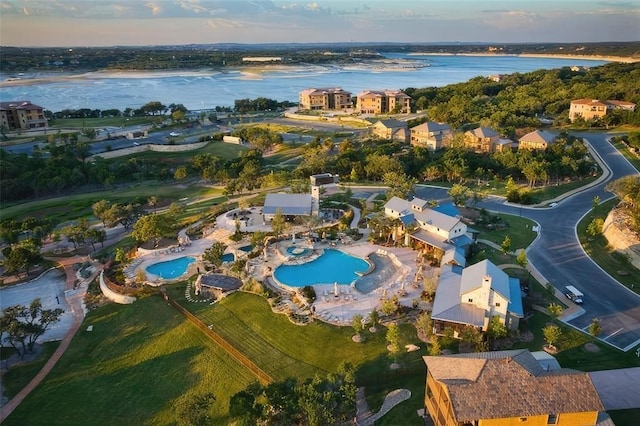 aerial view at dusk featuring a water view