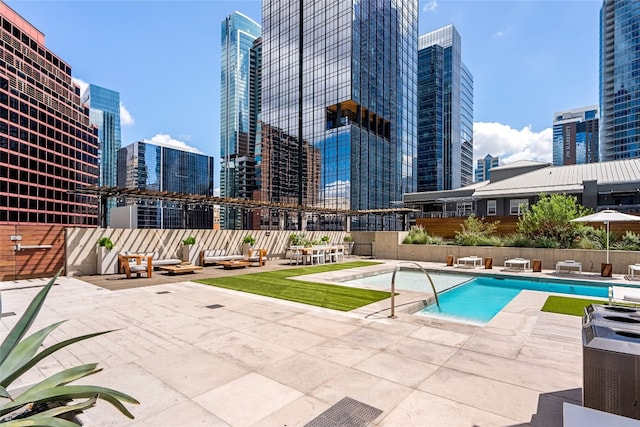 view of swimming pool with a patio area and central air condition unit