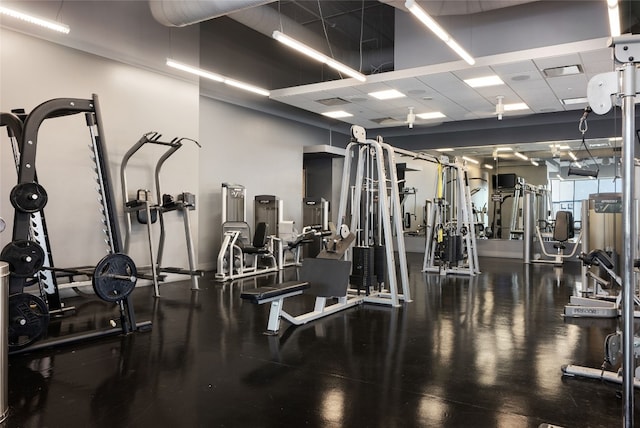 exercise room with a paneled ceiling