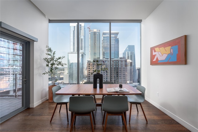 dining area featuring plenty of natural light and dark hardwood / wood-style floors