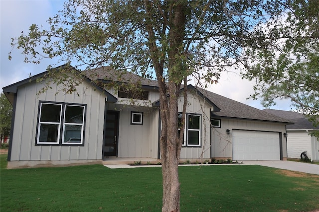 view of front of house featuring driveway, an attached garage, a front yard, and board and batten siding