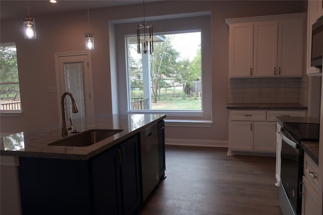 kitchen with decorative light fixtures, stainless steel appliances, white cabinets, and a wealth of natural light