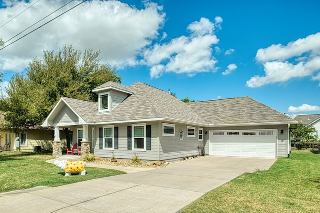 view of front of house with a garage and a front lawn