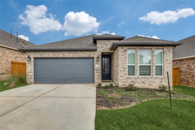 view of front of home featuring a front lawn and a garage