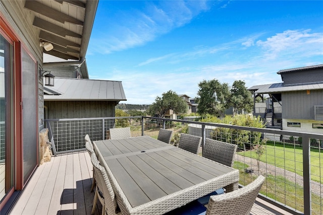 wooden deck with a lawn