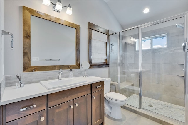 bathroom featuring vanity, lofted ceiling, toilet, an enclosed shower, and tile patterned flooring