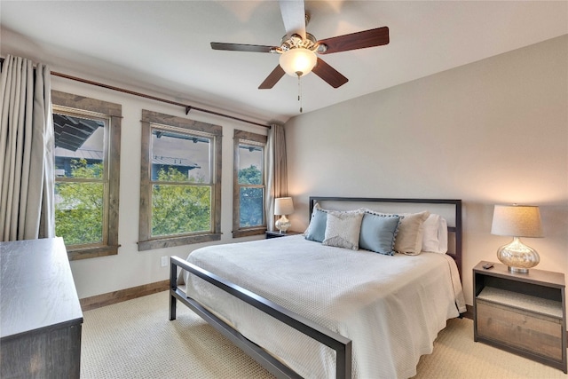 bedroom featuring ceiling fan and light carpet