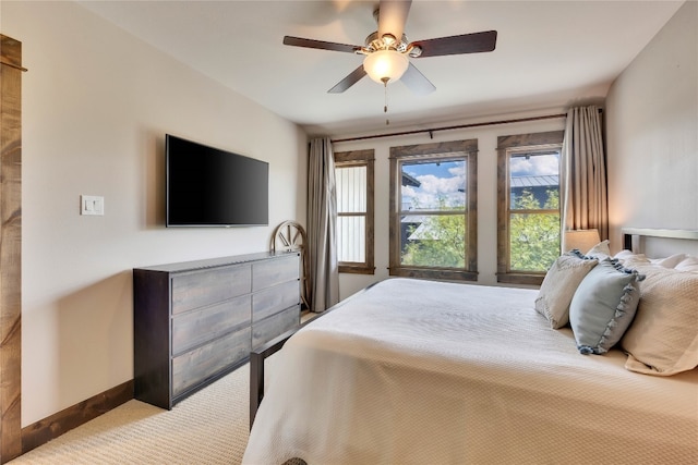 bedroom featuring ceiling fan and light carpet