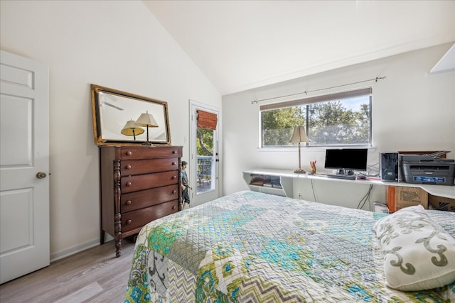 bedroom with lofted ceiling and light wood-type flooring