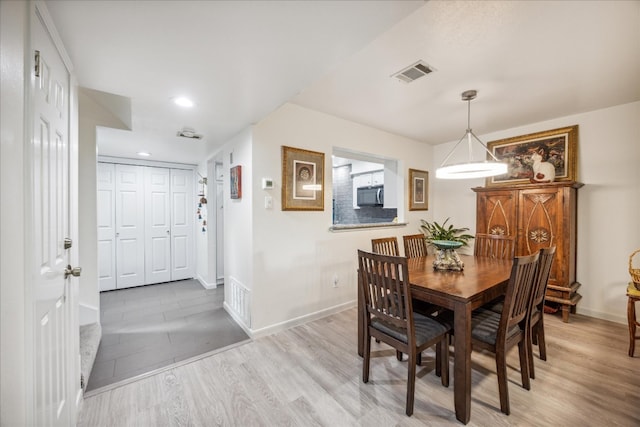 dining area with light hardwood / wood-style floors