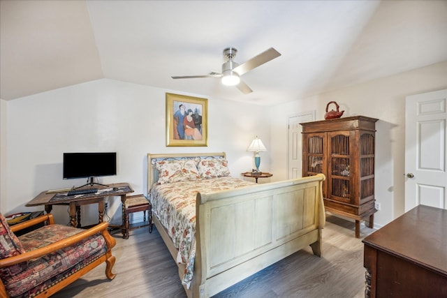 bedroom with ceiling fan, dark hardwood / wood-style flooring, and vaulted ceiling