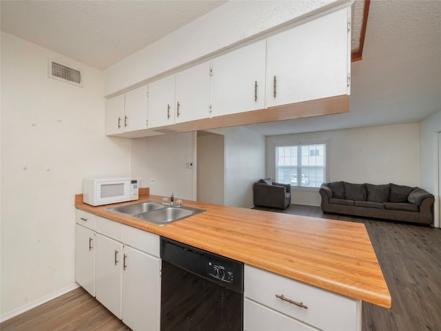 kitchen featuring dishwasher, a textured ceiling, dark hardwood / wood-style floors, sink, and white cabinets