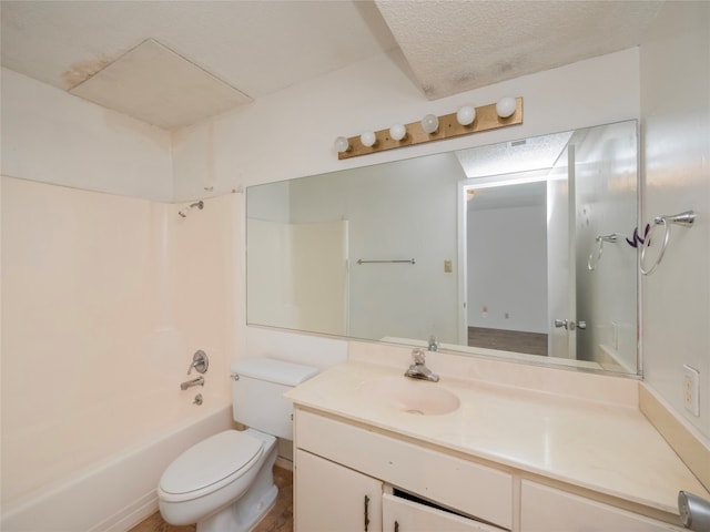 full bathroom featuring a textured ceiling, bathing tub / shower combination, vanity, and toilet