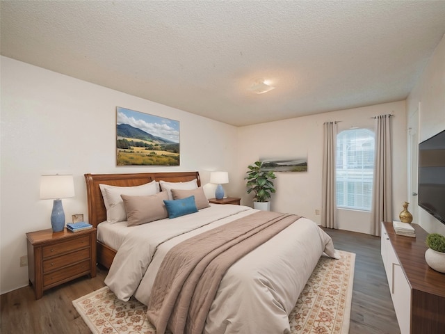 bedroom featuring a textured ceiling and dark hardwood / wood-style floors