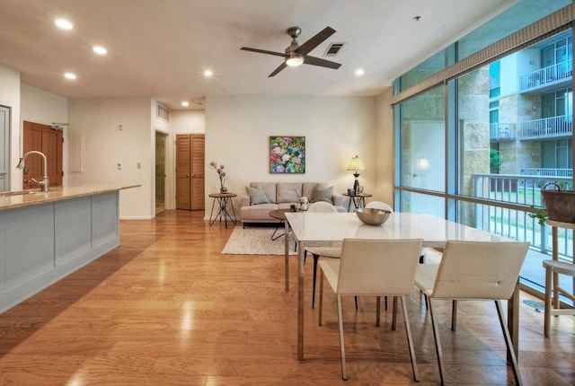 dining room featuring ceiling fan and light hardwood / wood-style flooring