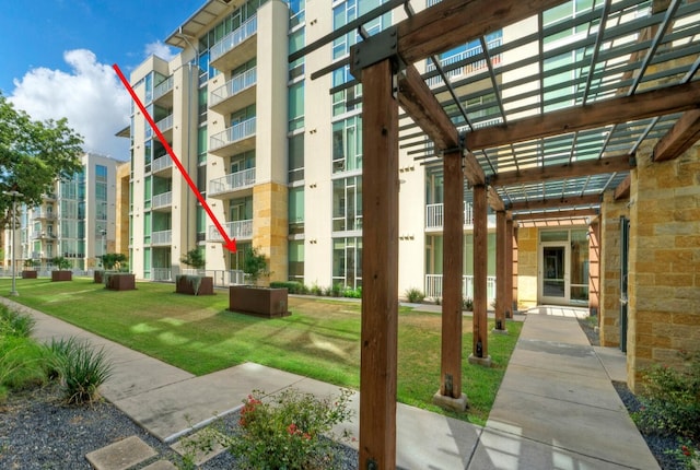 exterior space featuring a pergola and a yard