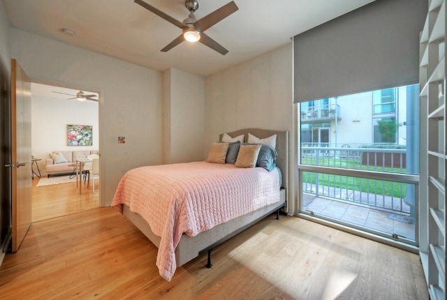 bedroom featuring light wood-type flooring, ceiling fan, and access to outside