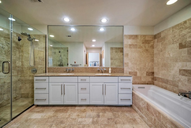 bathroom featuring vanity and plus walk in shower