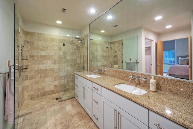 bathroom with walk in shower and vanity