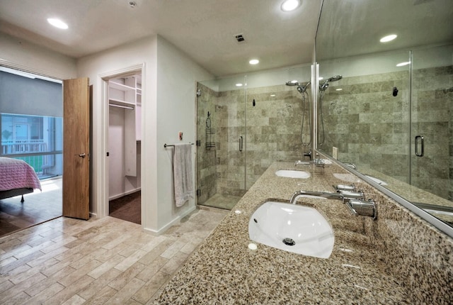 bathroom featuring walk in shower and vanity