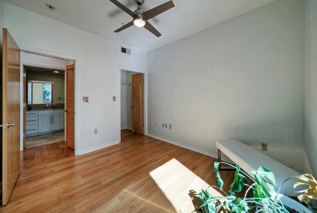 unfurnished bedroom with ceiling fan and light wood-type flooring