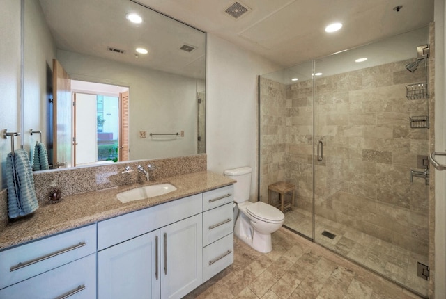 bathroom featuring walk in shower, vanity, and toilet