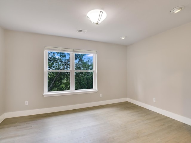 unfurnished room with light hardwood / wood-style flooring