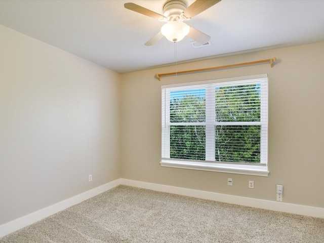 carpeted spare room with ceiling fan