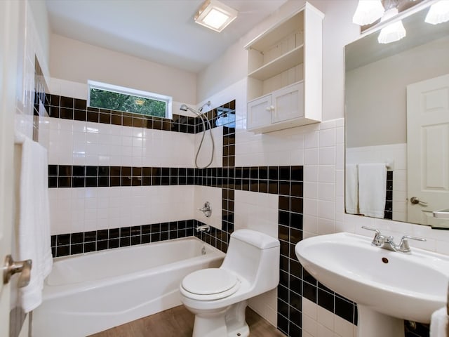 full bathroom with wood-type flooring, sink, toilet, tile walls, and shower / bath combination