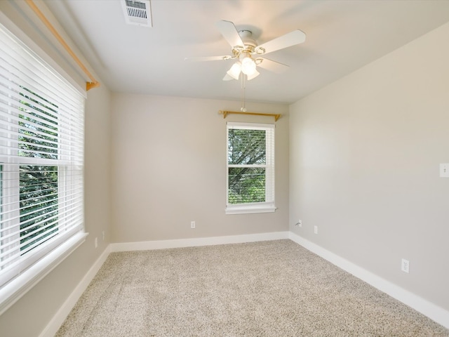 empty room with ceiling fan and carpet floors