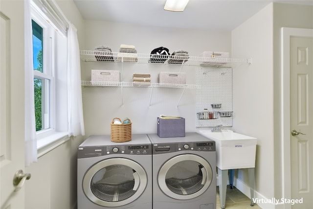 clothes washing area with washer and clothes dryer