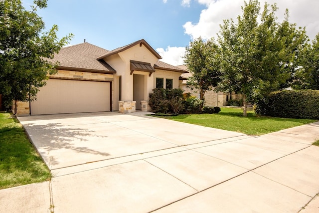 view of front of home with roof with shingles, driveway, stucco siding, a front lawn, and a garage