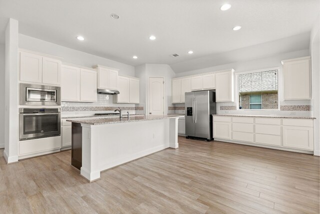 kitchen featuring under cabinet range hood, stainless steel appliances, light wood-style floors, and white cabinetry