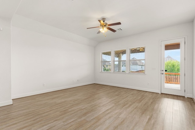 spare room with light hardwood / wood-style flooring, a wealth of natural light, and ceiling fan