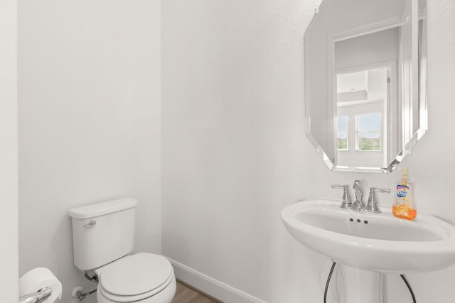 bathroom featuring toilet and sink