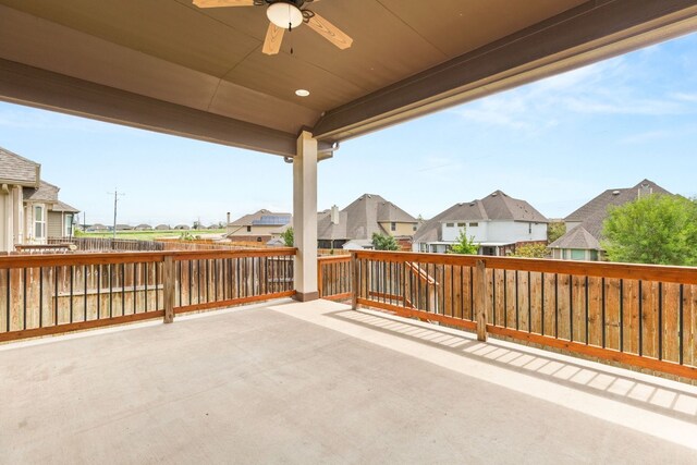 view of patio / terrace featuring a residential view, a ceiling fan, and fence