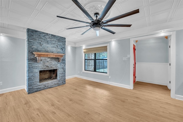 unfurnished living room with light hardwood / wood-style floors, a fireplace, and ceiling fan